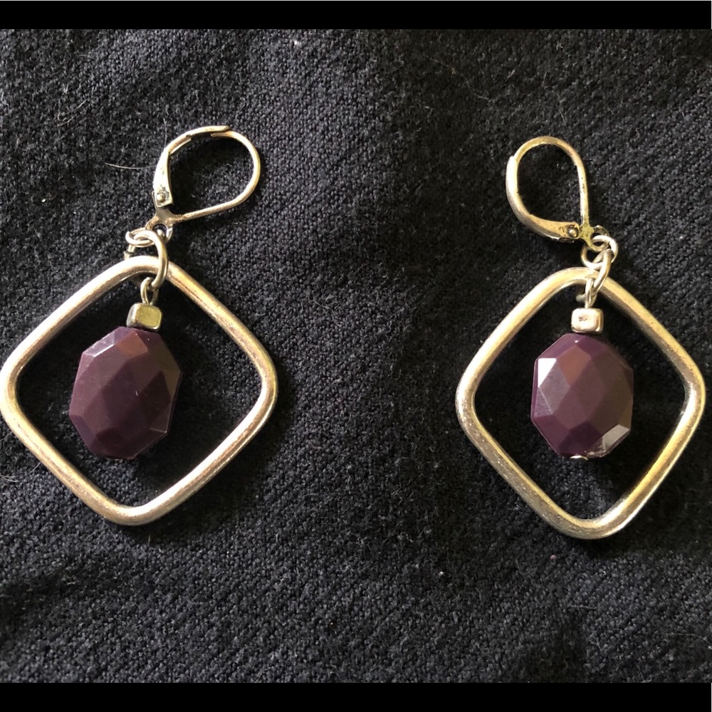 Silver tone metal earrings with purple beads